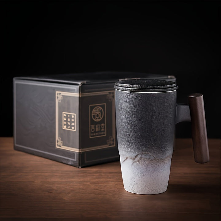 Stylish black handmade ceramic tea mug with strainer; artistic retro design, perfect for tea.