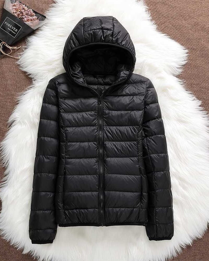Elegant women's waterproof outerwear coat. Versatile, lightweight design for comfortable all-weather wear.
