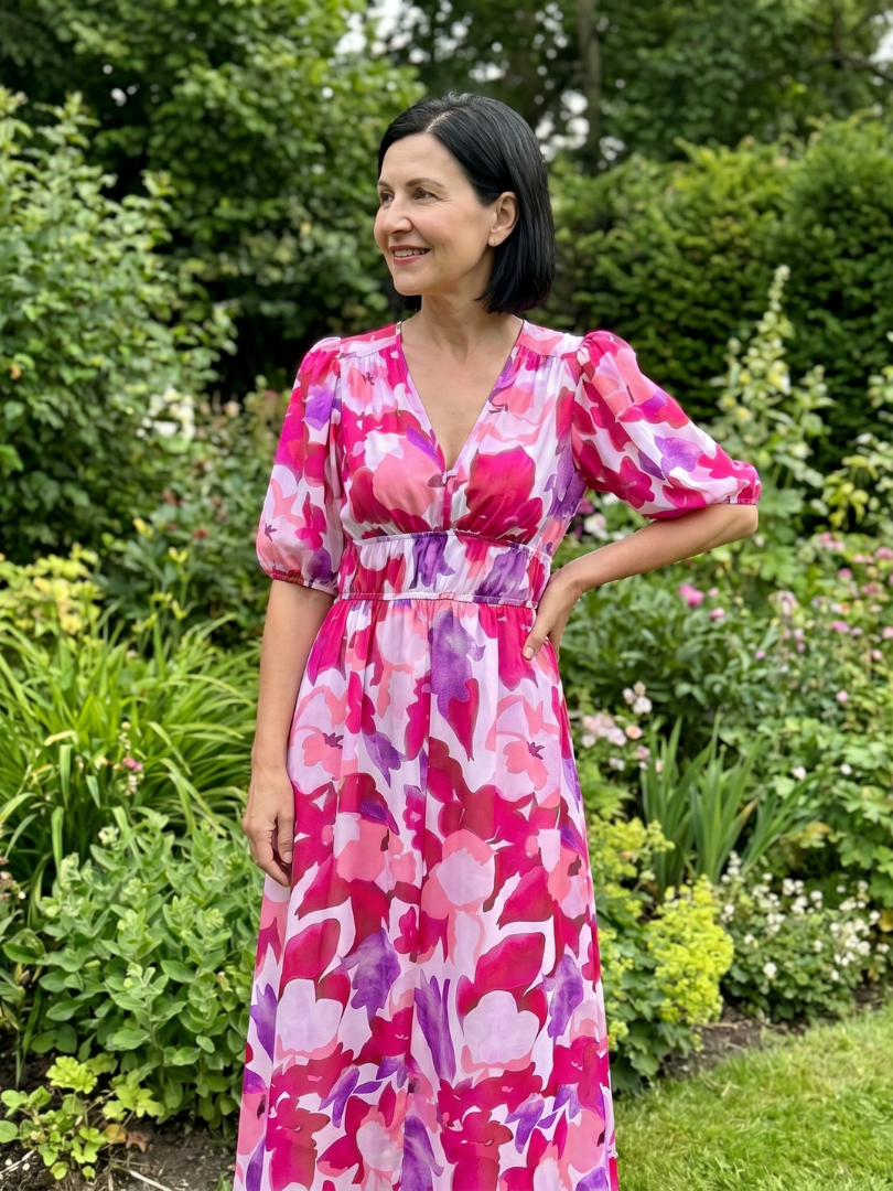 Back view of the women's abstract print midi dress, showcasing puff sleeves and elegant midi length.