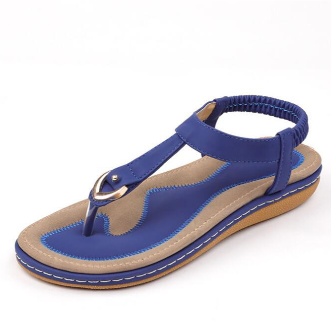 Women's T-strap flat sandals with an elastic back strap and cushioned sole for summer comfort.