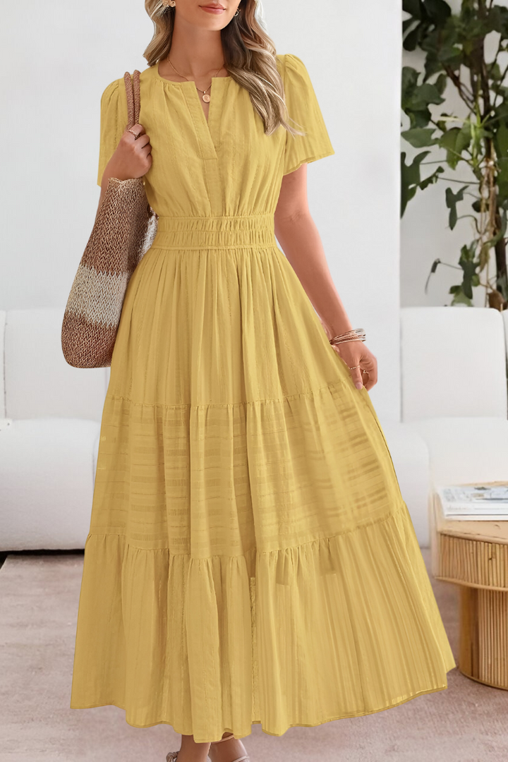 Women's short-sleeve bohemian smocked midi dress, flowy & comfortable, perfect for summer fashion.