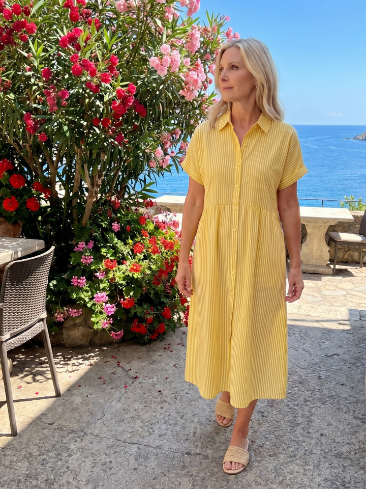 Women's collared striped short sleeve midi dress with a button-front, perfect for relaxed spring fashion.