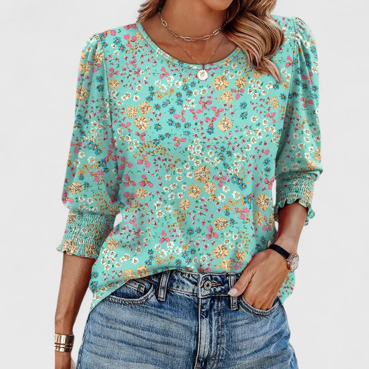 Elegant women's smocked top styled for effortless summer fashion, a chic casual wear blouse.
