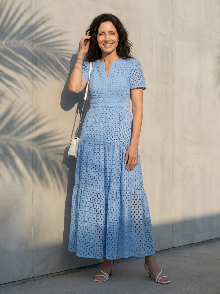 Light blue V-neck short sleeve tiered midi dress with smocked waist. Eyelet detail for summer style.