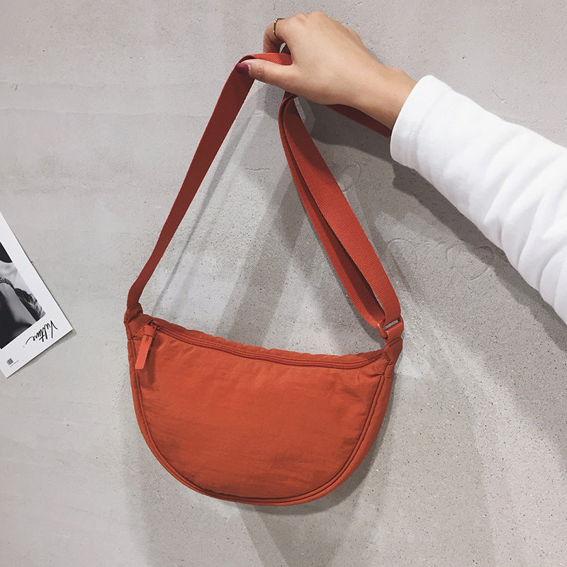 Sleek Half Moon Crossbody Bag for women, featuring a versatile design & adjustable strap.