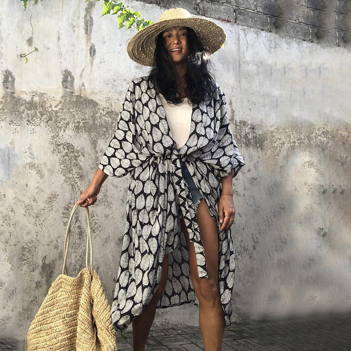 Glamorous women's beach cover up, elegant resort wear providing chic sun protection.
