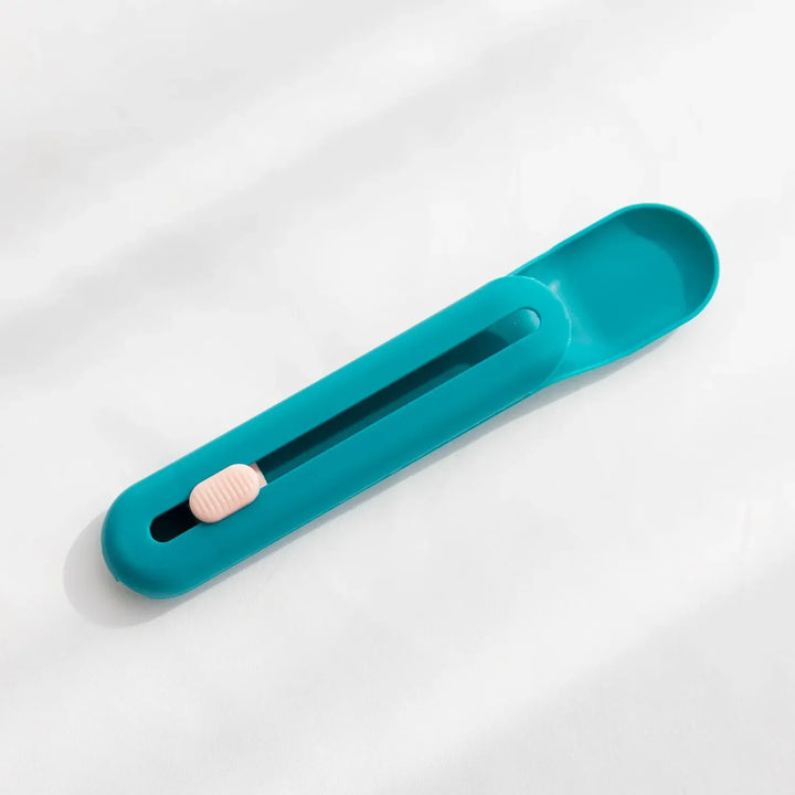 Hygienic pet food feeding spoon and dispenser, ensuring mess-free serving of wet cat or dog food.