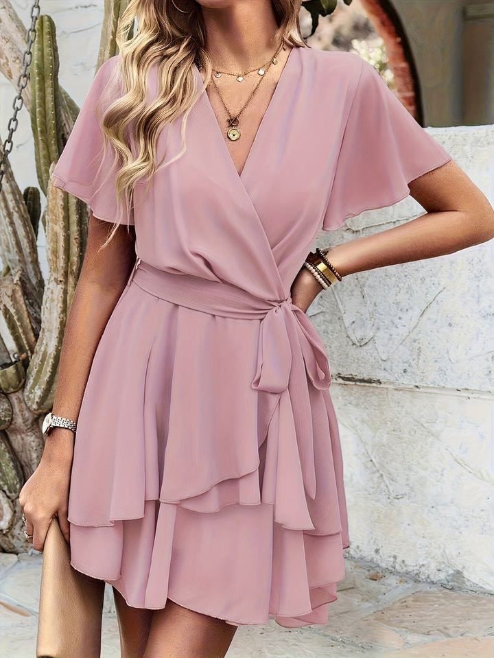 Feminine pink short sleeve flowy dress for women, suitable for elegant daily wear or comfortable summer casuals.