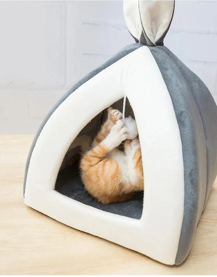 Stylish pet bed: a cozy, enclosed cave for cats to sleep, hide, and play with the integrated ball.