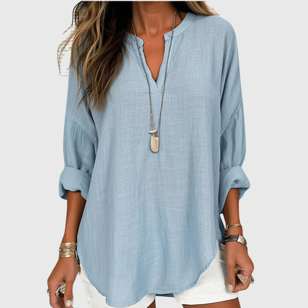 Women's flowing elegant beach shirt in white, perfect for sunny summer days.