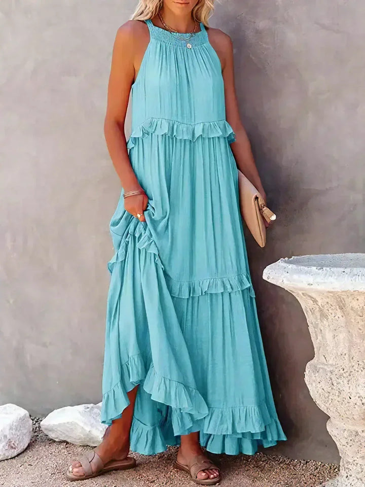 Casual women's summer dress: halterneck, ruffles, maxi length & convenient pockets.