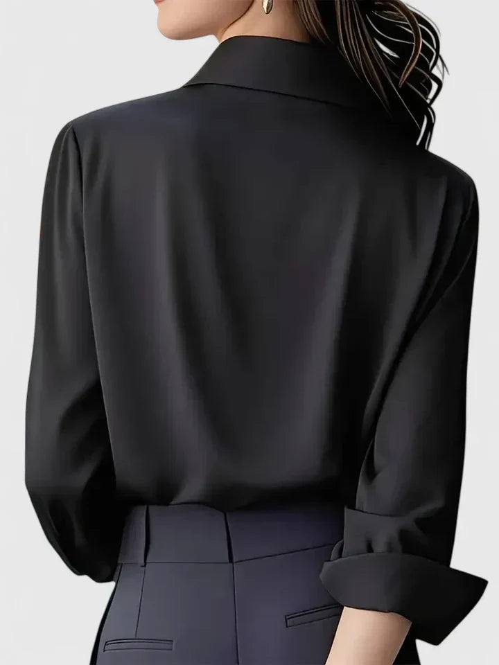 Classic women's long sleeve button-down blouse with a stylish curved hem. An elegant wardrobe essential.