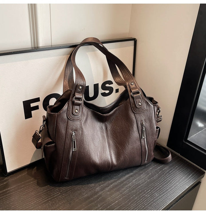 Fashionable women's black tote bag made from durable vegan leather, suitable as a chic shoulder bag.