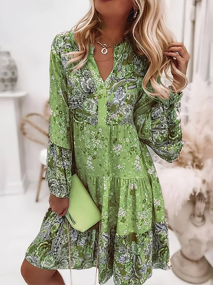 Vibrant women's floral print boho mini dress in pink, green, and blue hues, ideal for summer fashion.
