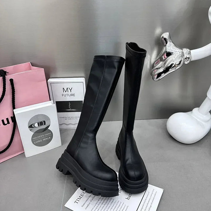 Elegant women's long black boots, perfect for winter style and comfort. Stylish and versatile tall fashion footwear.