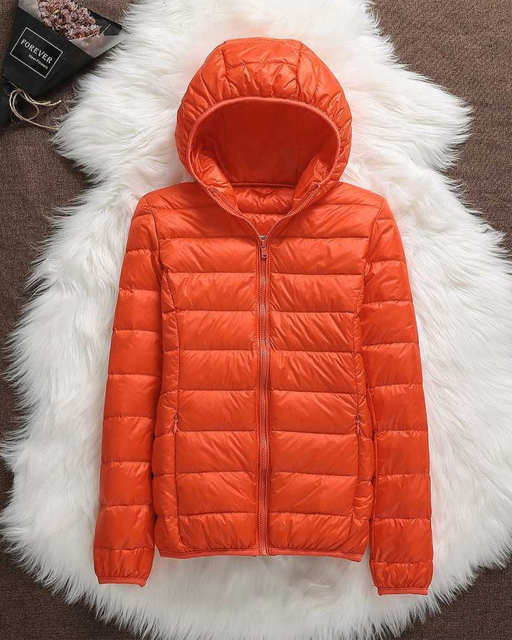 Modern women's lightweight waterproof jacket. Elegant all-weather coat offering comfort & versatile protection.