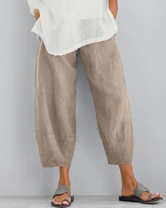 Women's relaxed fit cropped trousers in black with elasticated waist & pockets for everyday comfort & style.