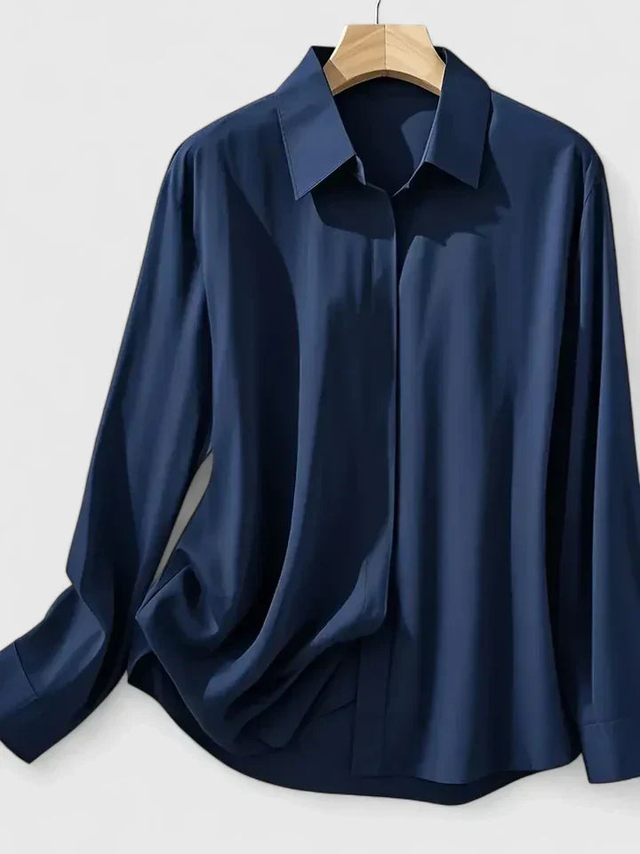 Chic women's button-down top, elegant for office wear or sophisticated casual occasions. Long sleeve design.