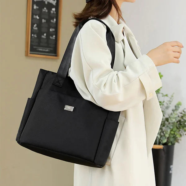 Rose pink waterproof shoulder bag for women. Lightweight, durable, and versatile fashion accessory.