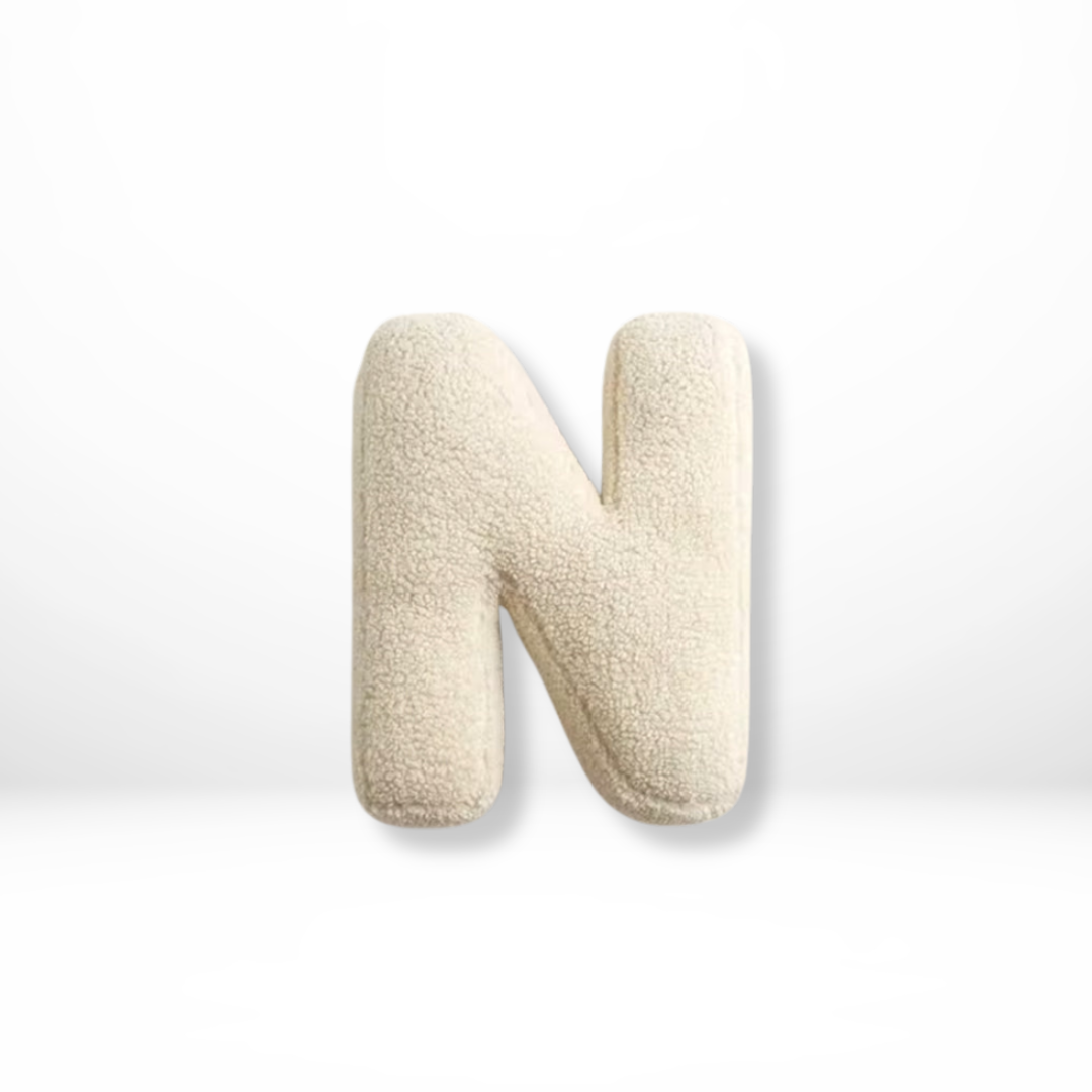 Decorative velvet 'R' letter pillow, a cozy furnishing for sophisticated home interior style.