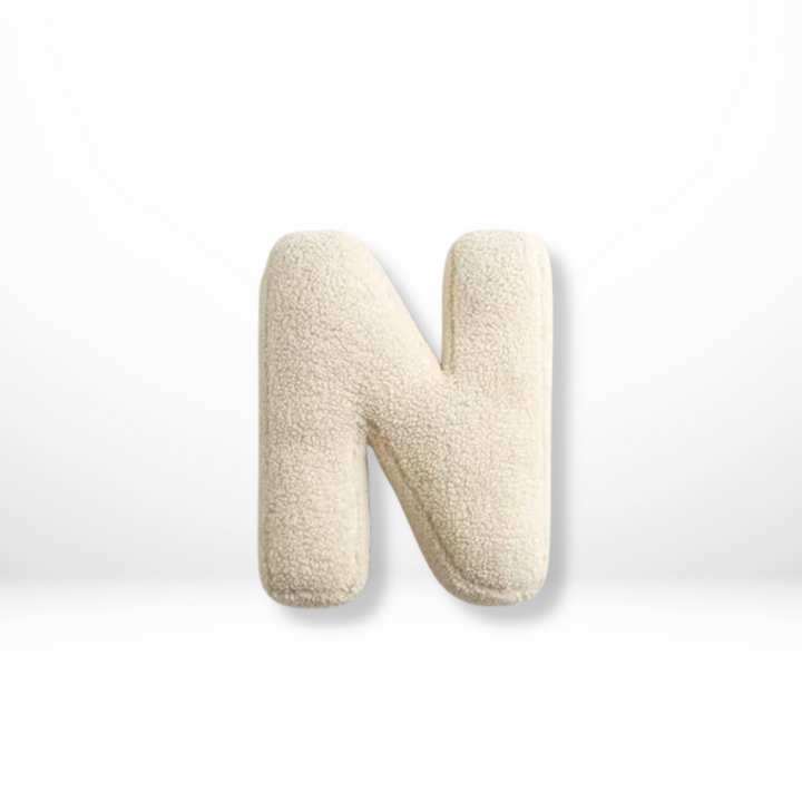 Decorative velvet 'R' letter pillow, a cozy furnishing for sophisticated home interior style.