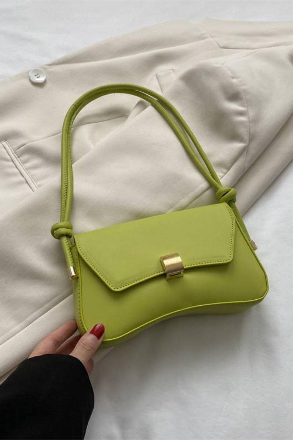 Chic women's minimalist shoulder flap bag with a distinctive gold clasp, available in multiple colors.