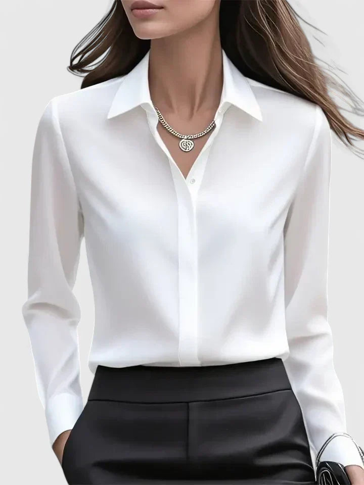 Soft, elegant women's button-down blouse. Versatile long sleeve top with a modern curved hem.