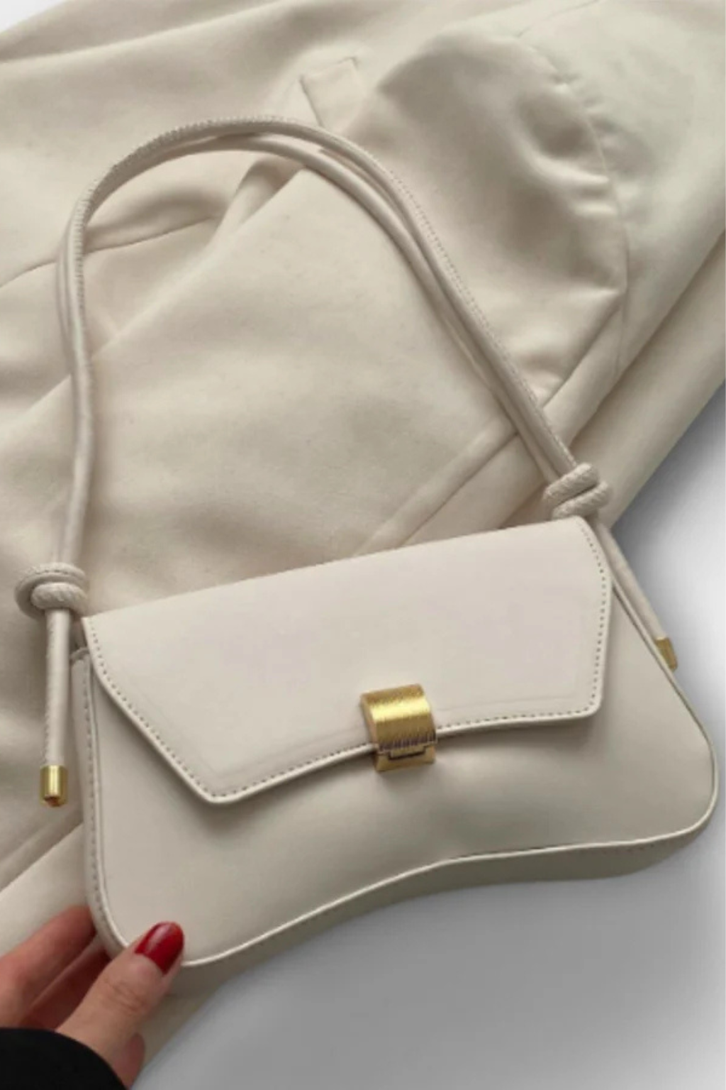 Green minimalist shoulder bag for women, featuring an elegant gold clasp & compact flap design.