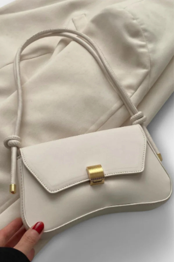 Green minimalist shoulder bag for women, featuring an elegant gold clasp & compact flap design.
