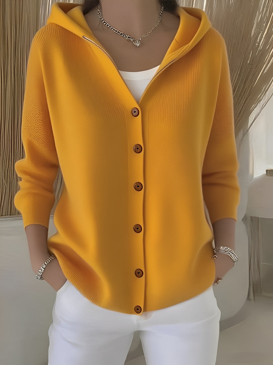 Relaxed fit women's hooded knitted cardigan, essential for spring and autumn layering.