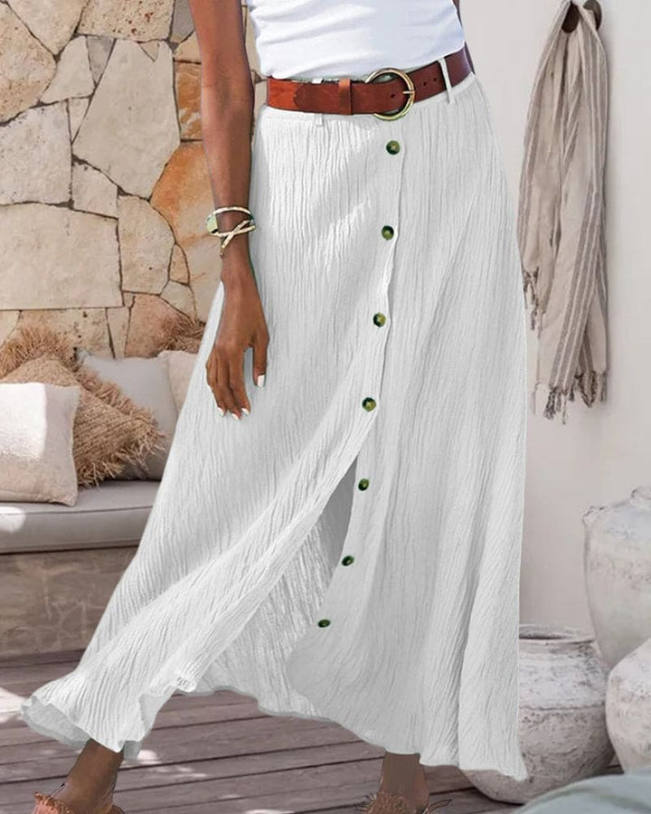 Flowing women's elegant maxi skirt with a full button-front, shown from a flattering side view.