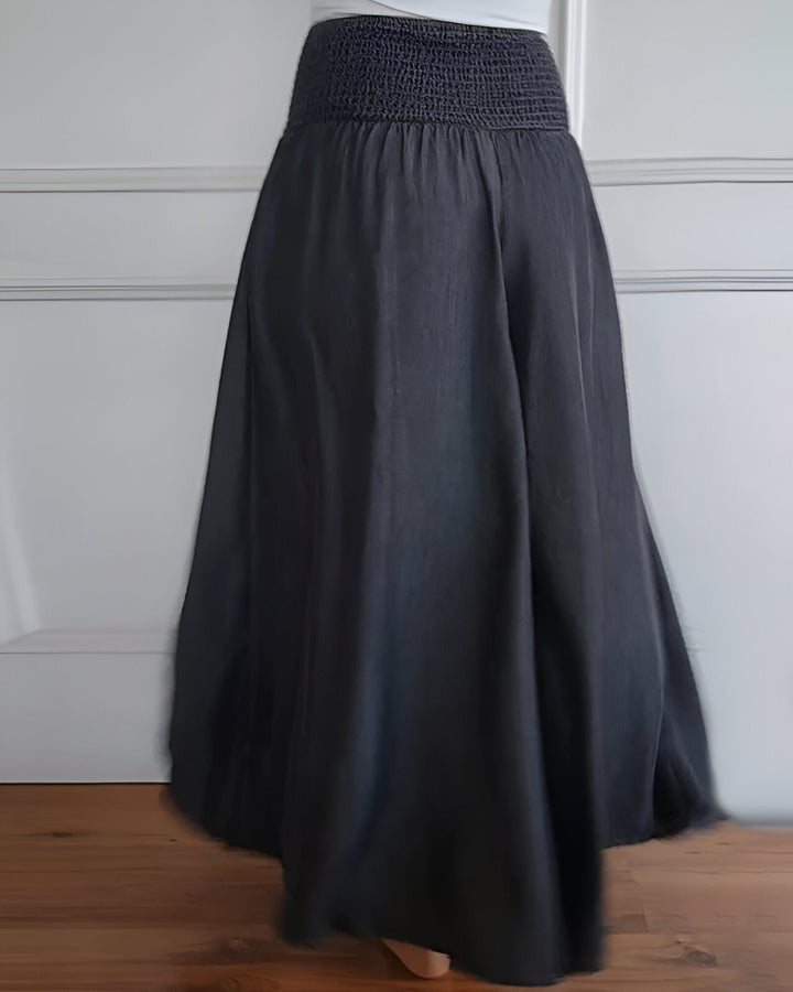 Effortless women's long skirt. Flowy fabric, smocked waist, & practical pockets for comfortable, versatile style.