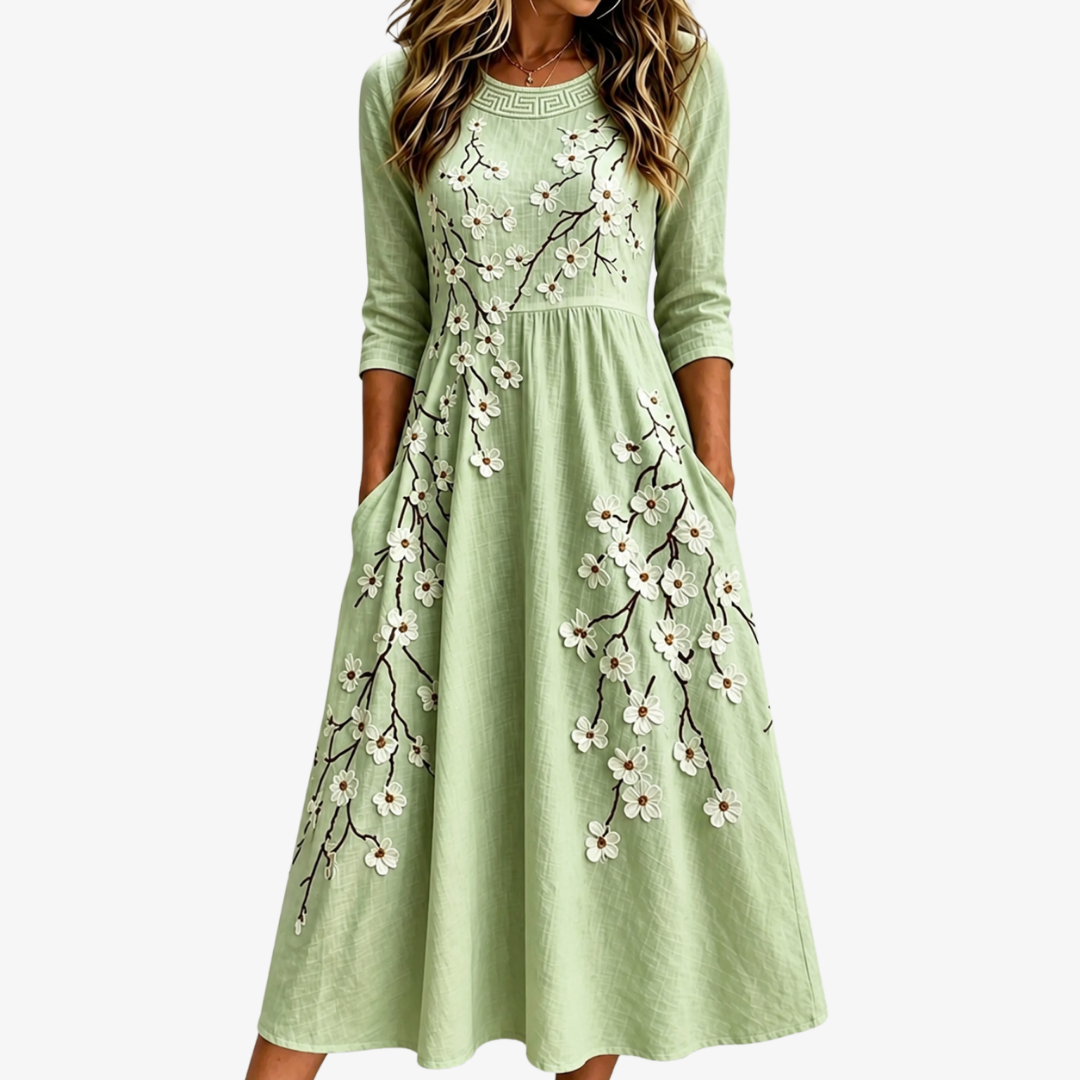 Women's sage blossom floral midi dress with pockets. Perfect for casual summer wear and everyday elegant style.
