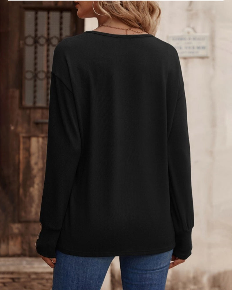 Chic women's V-neck long sleeve top with elegant button accents, ideal for versatile autumn fashion.