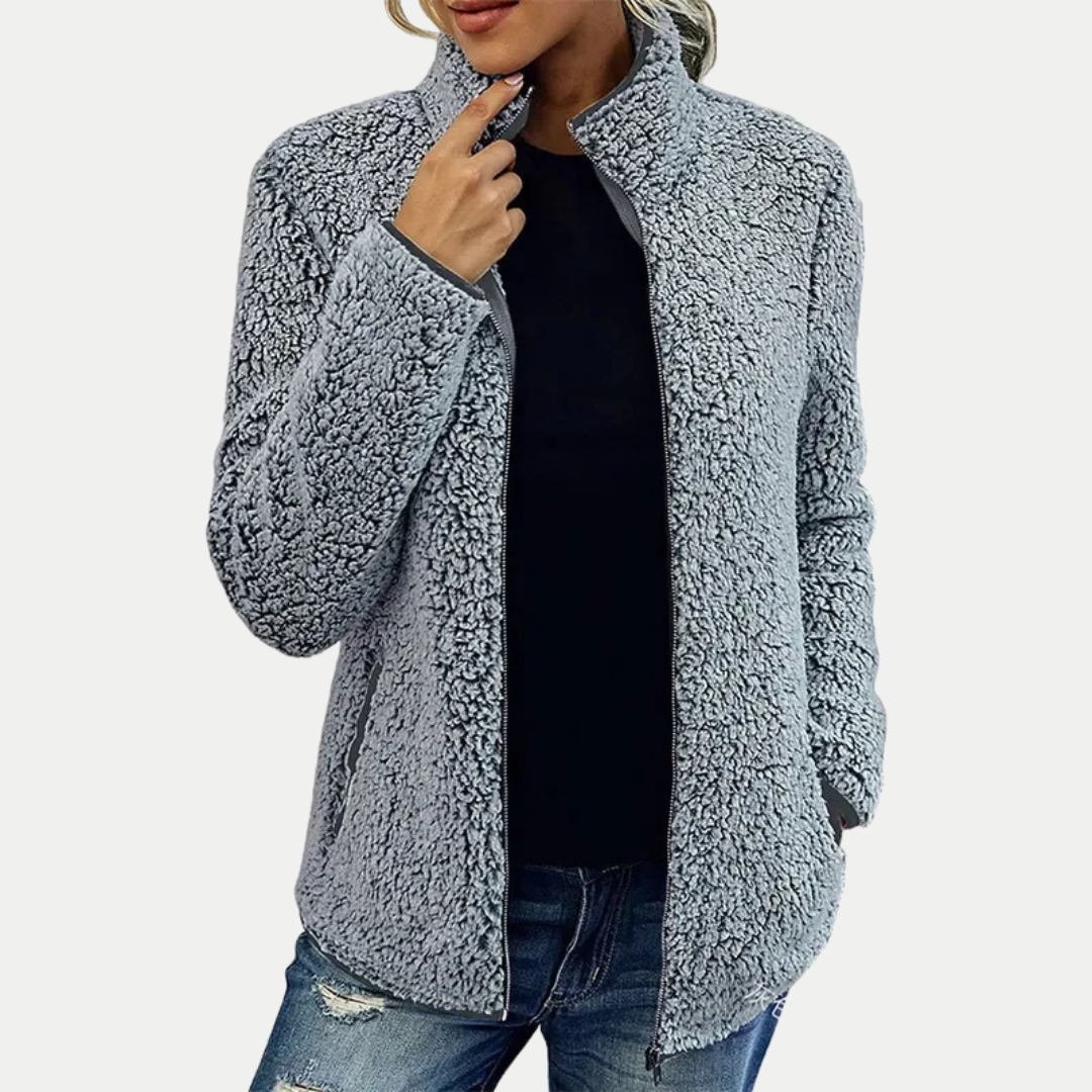 Distinctive textured pattern on a women's zip-up fleece jacket. High collar, long sleeve. Stylish casual women's outerwear.