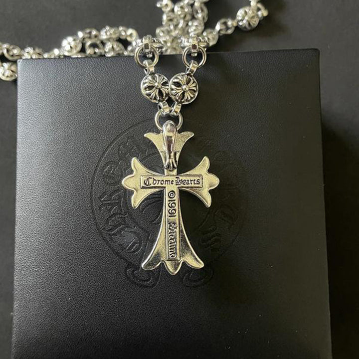 Silver-tone Gothic cross pendant on a chain, a unisex Y2K punk jewelry piece for an edgy look.