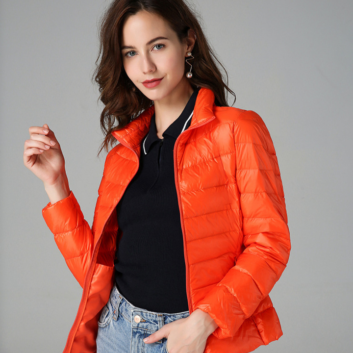 Packable women's ultralight waterproof jacket, great for stylish all-weather outdoor adventures & casual rain protection.