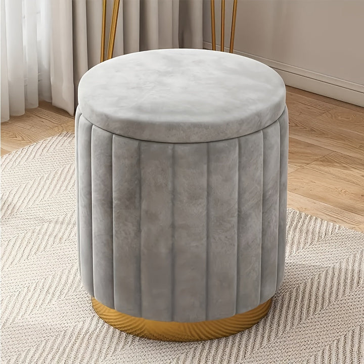 Contemporary round storage ottoman, mirror finish enhances living space.