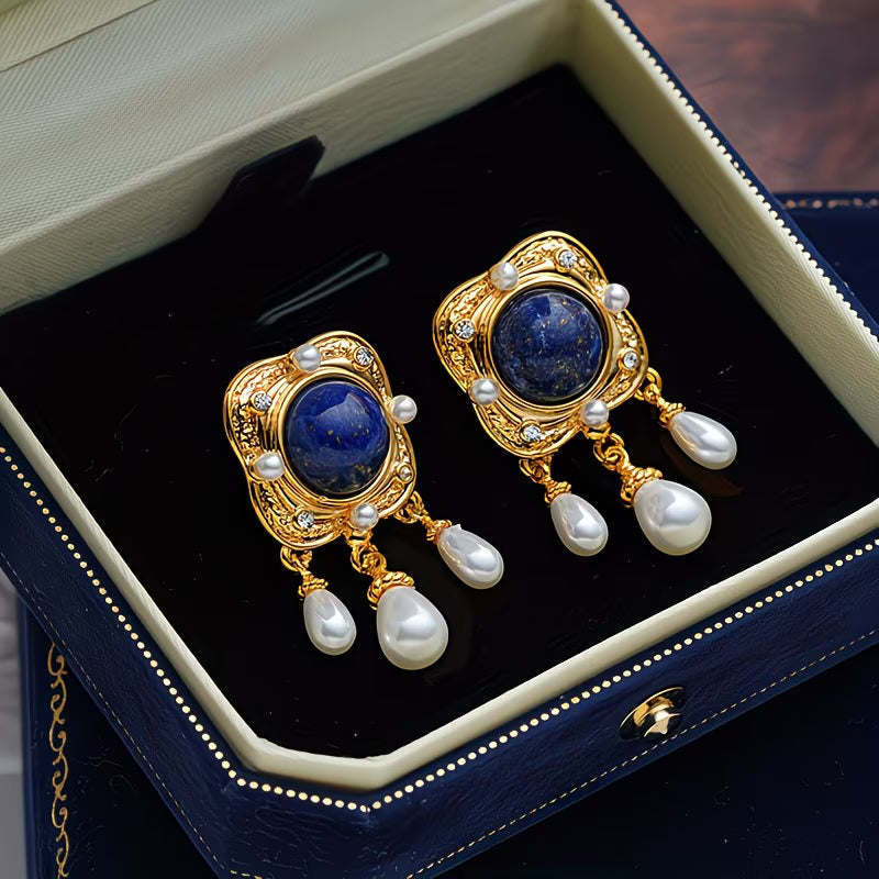 Stunning royal blue pearl drop chandelier earrings for women. A hypoallergenic statement jewelry piece.
