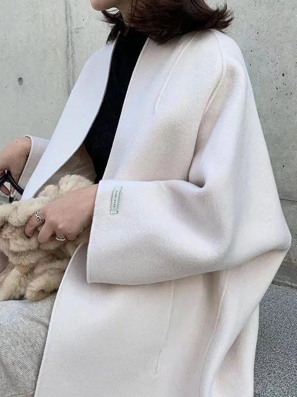 Women's elegant long brown winter coat, a must-have for chic outerwear and cozy warmth.