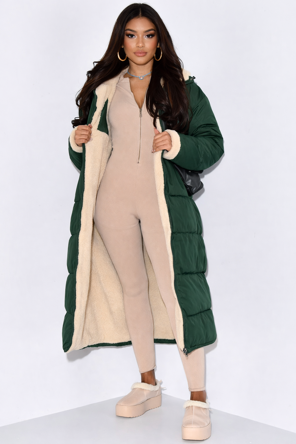 Versatile women's reversible longline winter coat. Hooded, warm, and quilted for stylish cold weather protection.
