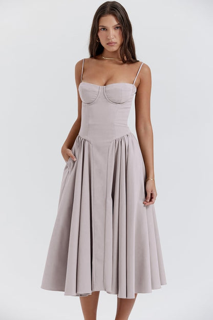 Elegant women's sleeveless midi dress with a fitted corset, ideal for wedding guests & formal events.