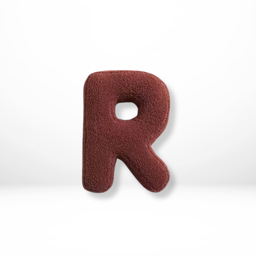 Elegant velvet 'V' letter cushion, ideal for initial decor and luxurious home interior styling.