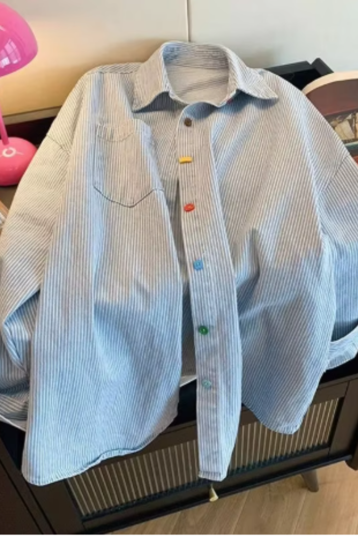 Stylish women's relaxed fit oversized striped button-down shirt, a versatile long-sleeve blouse for casual wear.