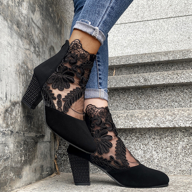 Front view: Fashion-forward women's block heel ankle boots, showcasing intricate lace embroidery on the upper.