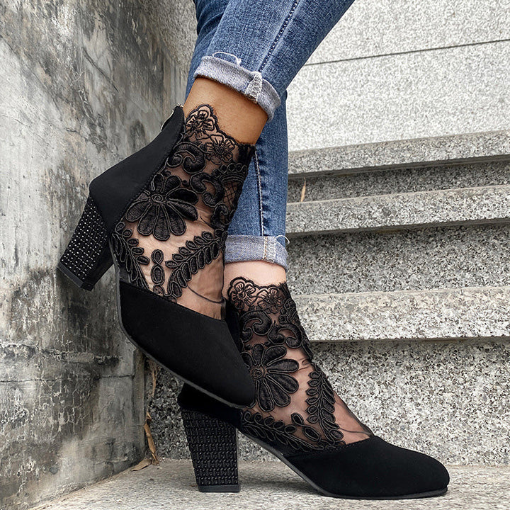 Front view: Fashion-forward women's block heel ankle boots, showcasing intricate lace embroidery on the upper.