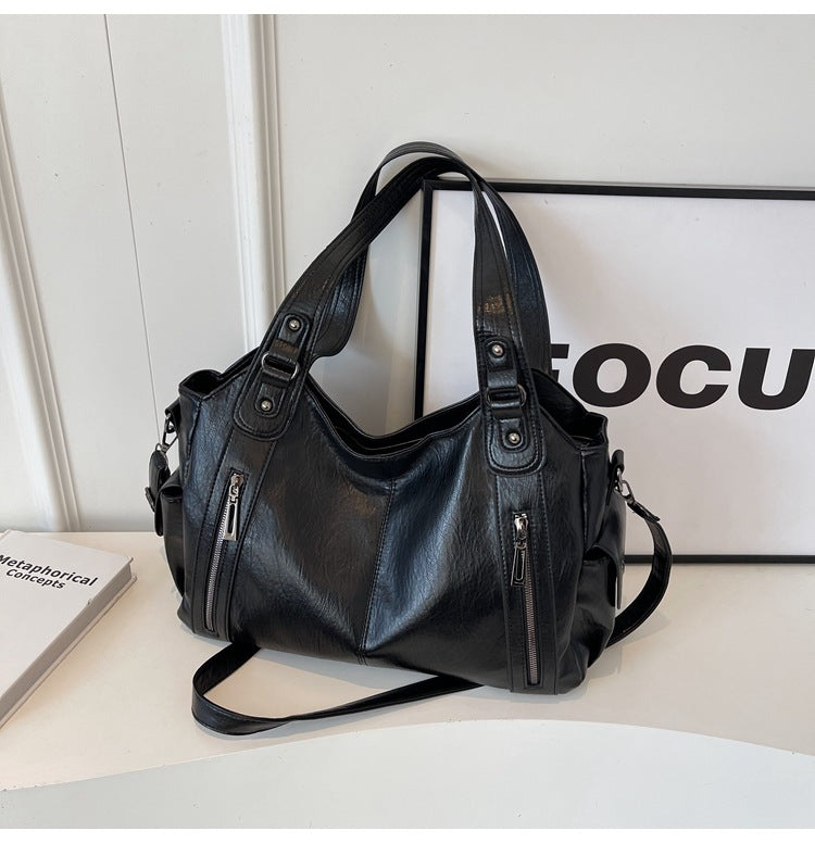 Versatile women's travel tote in tan vegan leather, functioning as a chic and spacious shoulder bag.