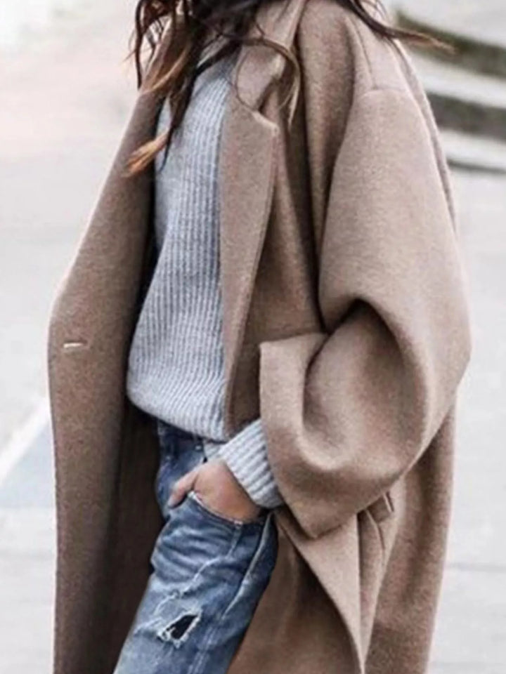 Elegant black oversized long winter coat for women, offering a relaxed fit and versatile casual style.