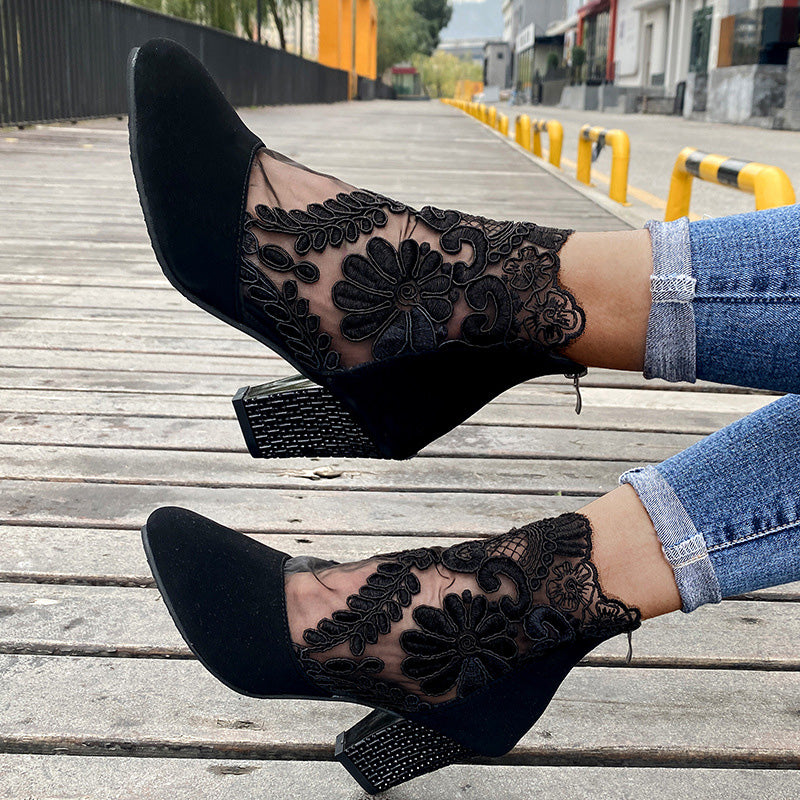 Side view: Elegant women's black ankle boots with delicate lace embroidery detail and a chic block heel design.