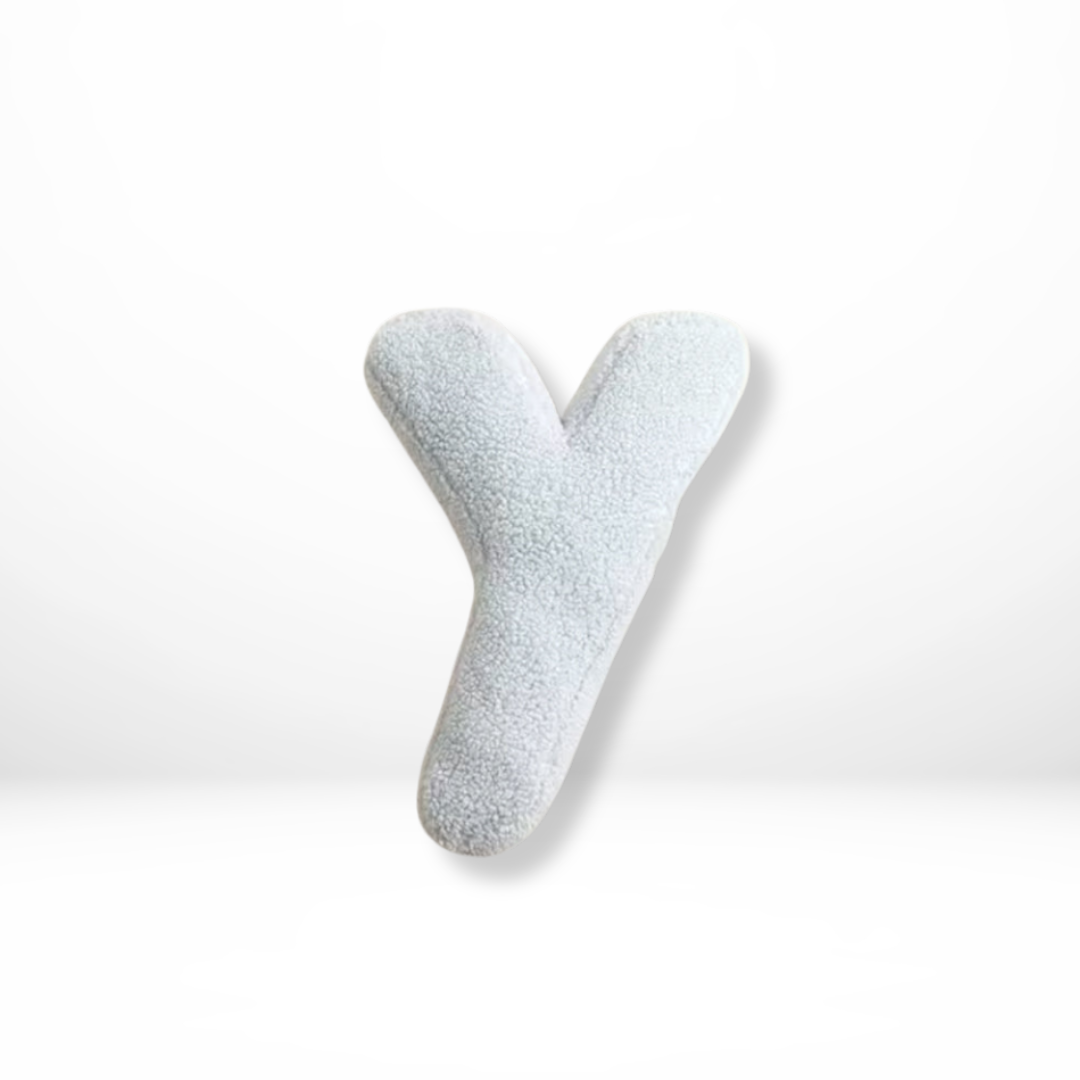Plush velvet alphabet cushion, a luxurious soft furnishing ideal for modern home interior decor.